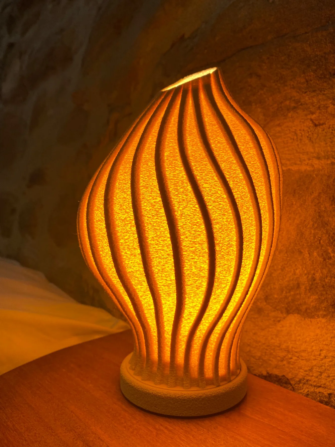 VLIV Luma lamp glowing beside a bed